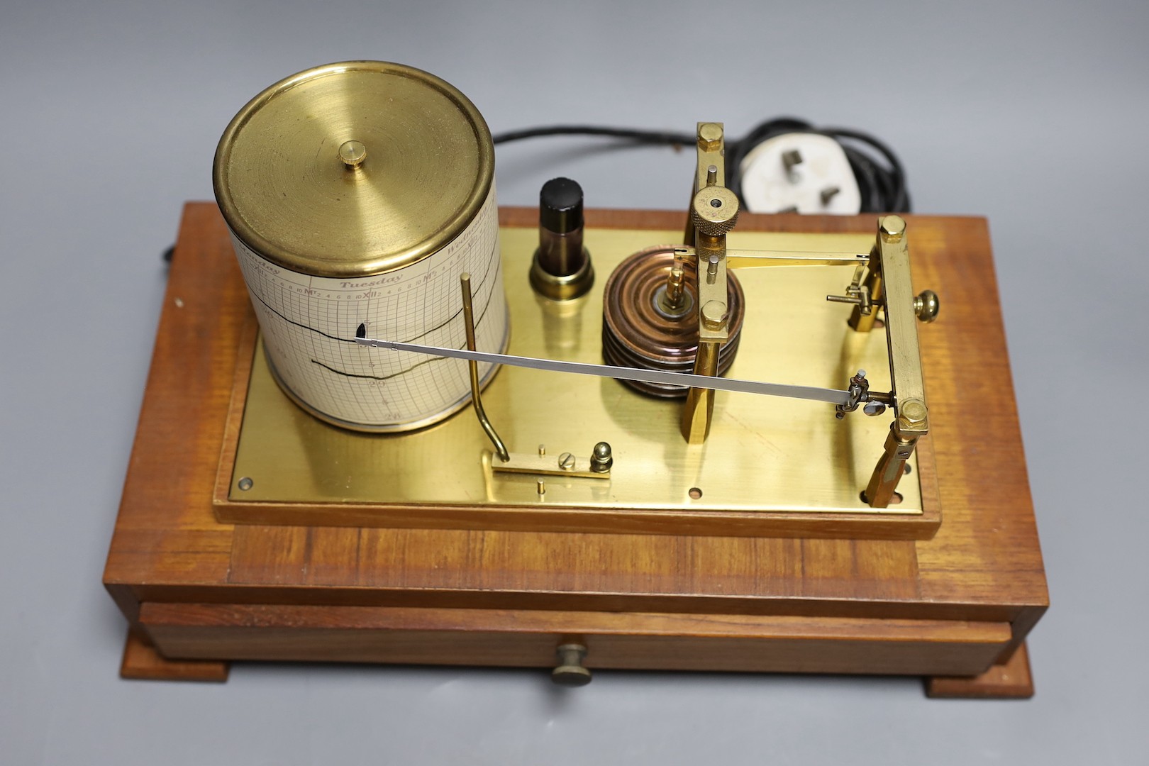 An unnamed brass barograph with spare graph paper in draw 37cm